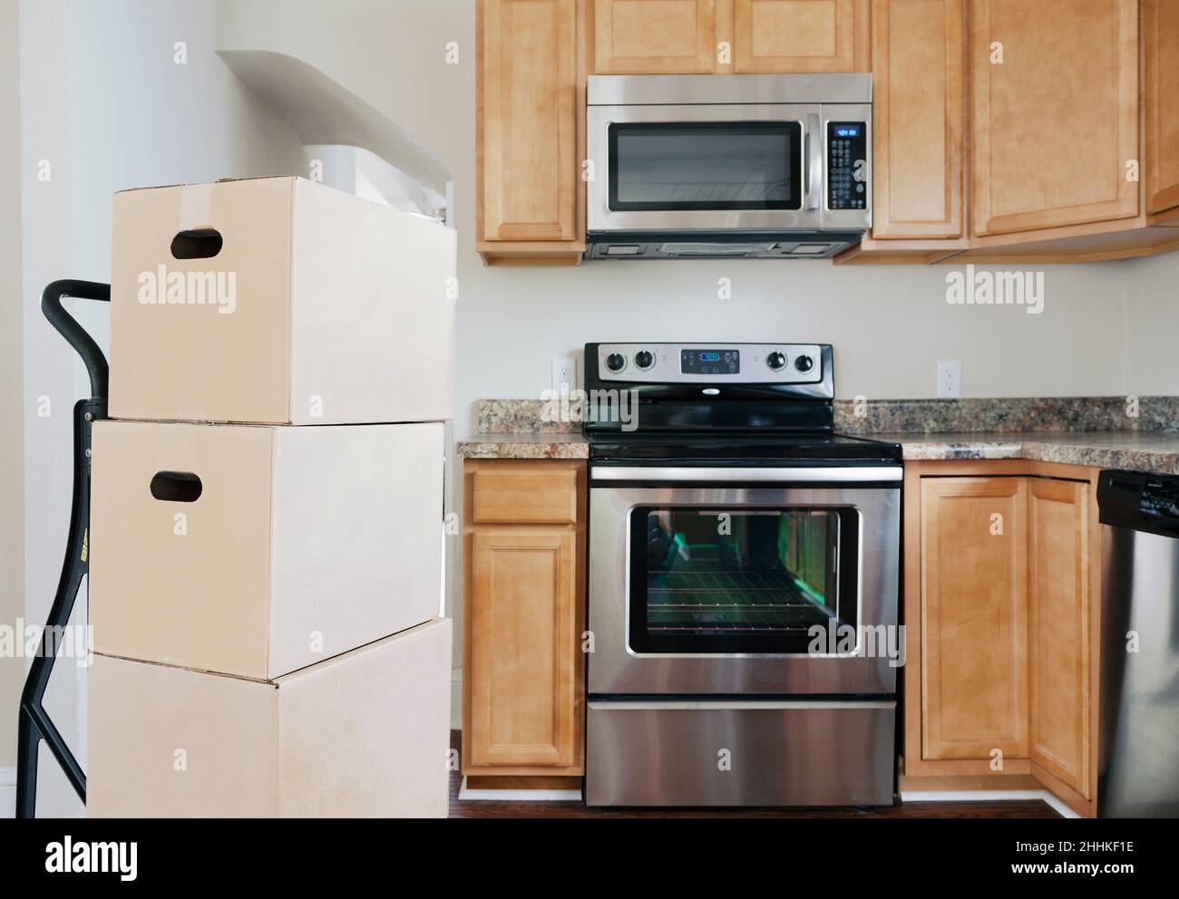 Moving boxes in kitchen Stock Photo - Alamy