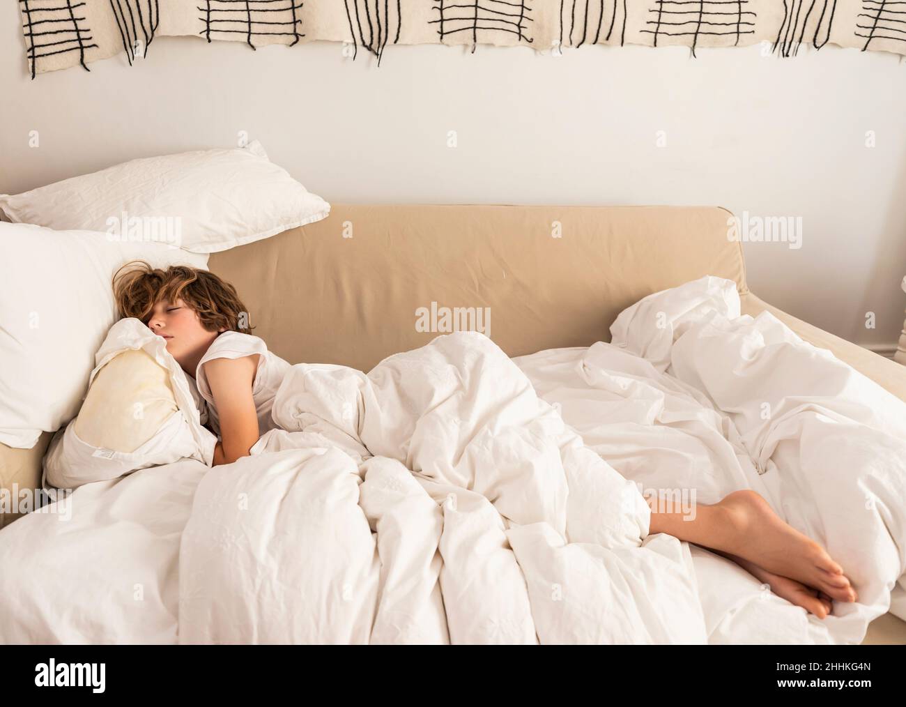Boy (8-9) sleeping on sofa Stock Photo