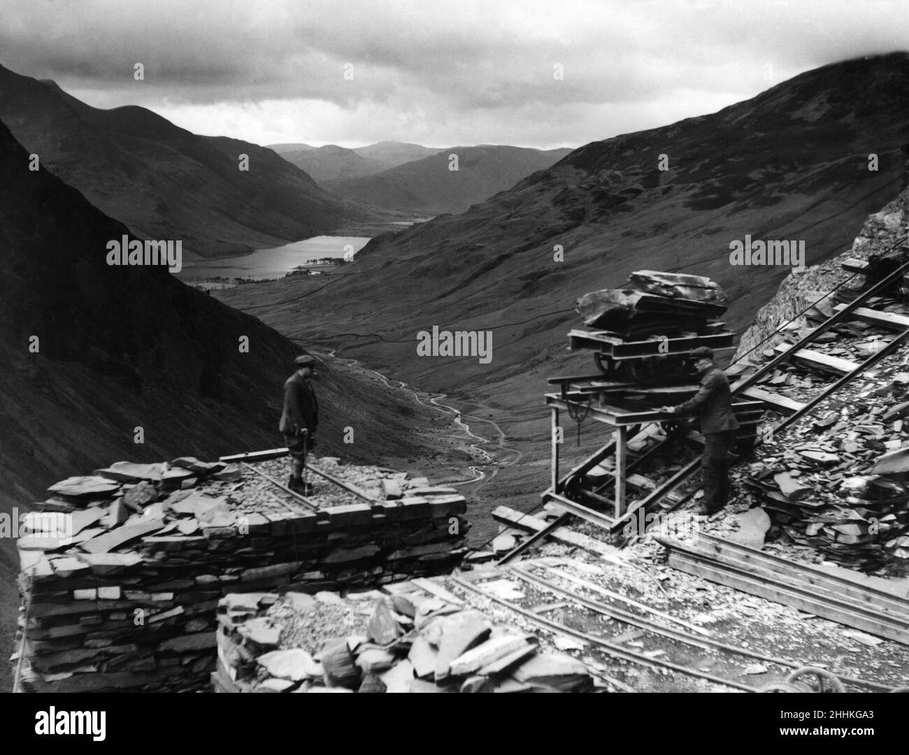 Quarrying green slate. Lowering slate down the side of Yew Crags on the east side of the Valley. In the distance in Buttermere. Lake District. 4th December 1934. Stock Photo