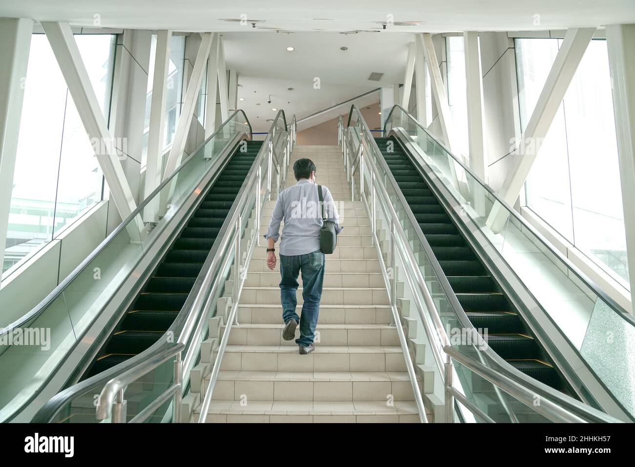 Man going up the stairs inside a subway station. Going back to work or transit concept. Stock Photo