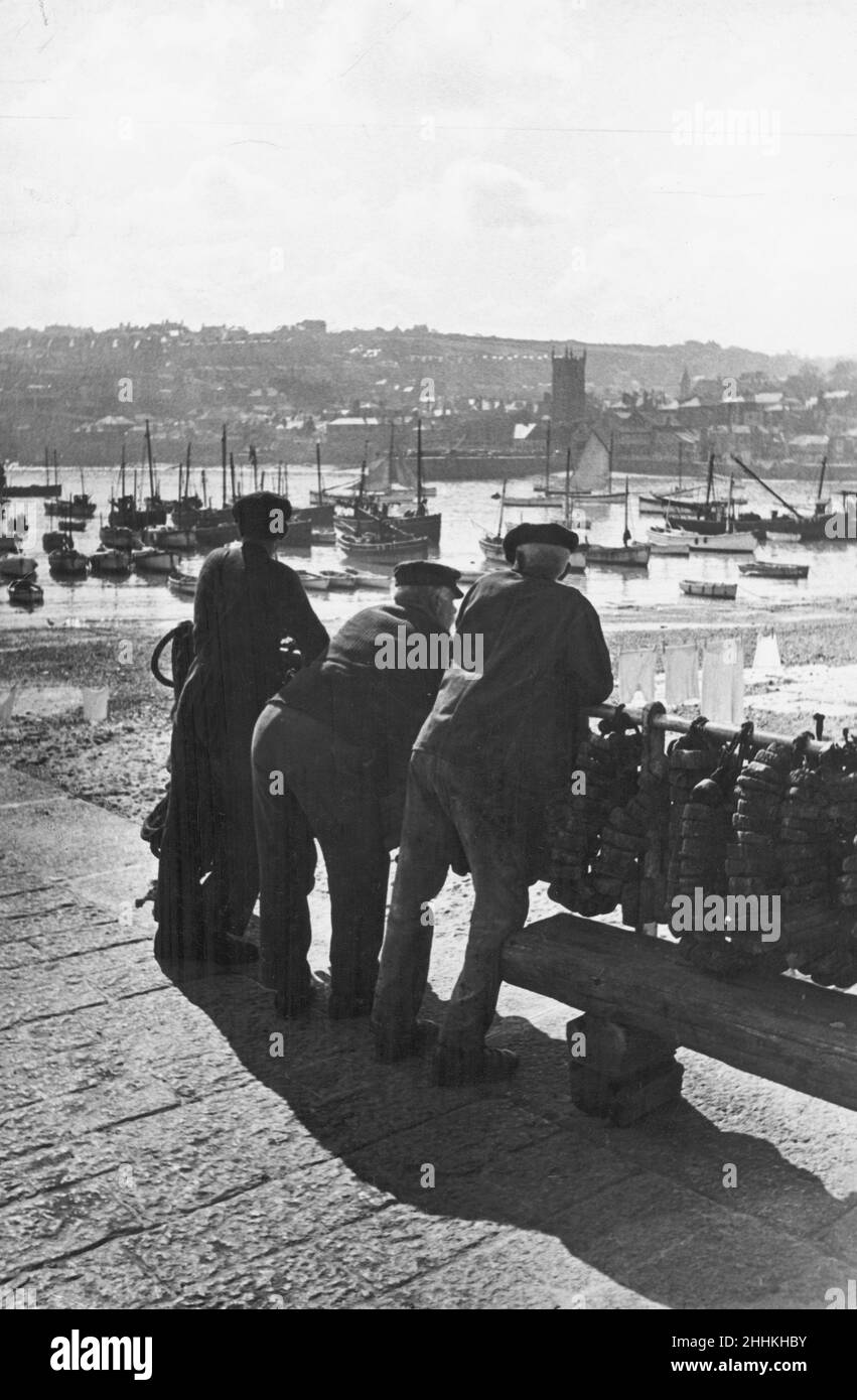 Three Cornish Fishermen Seen Here In St Ives Leaning On The Harbour three-cornish-fishermen-seen-here-in-st-ives-leaning-on-the-harbour