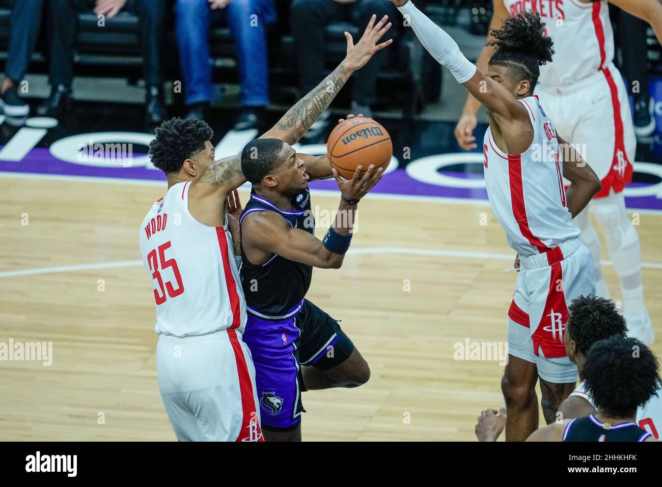 Sacramento Kings guard De'Aaron Fox (5) attempts a shot while being defended by Houston Rockets forward Christian Wood (35) at the NBA game between th Stock Photo