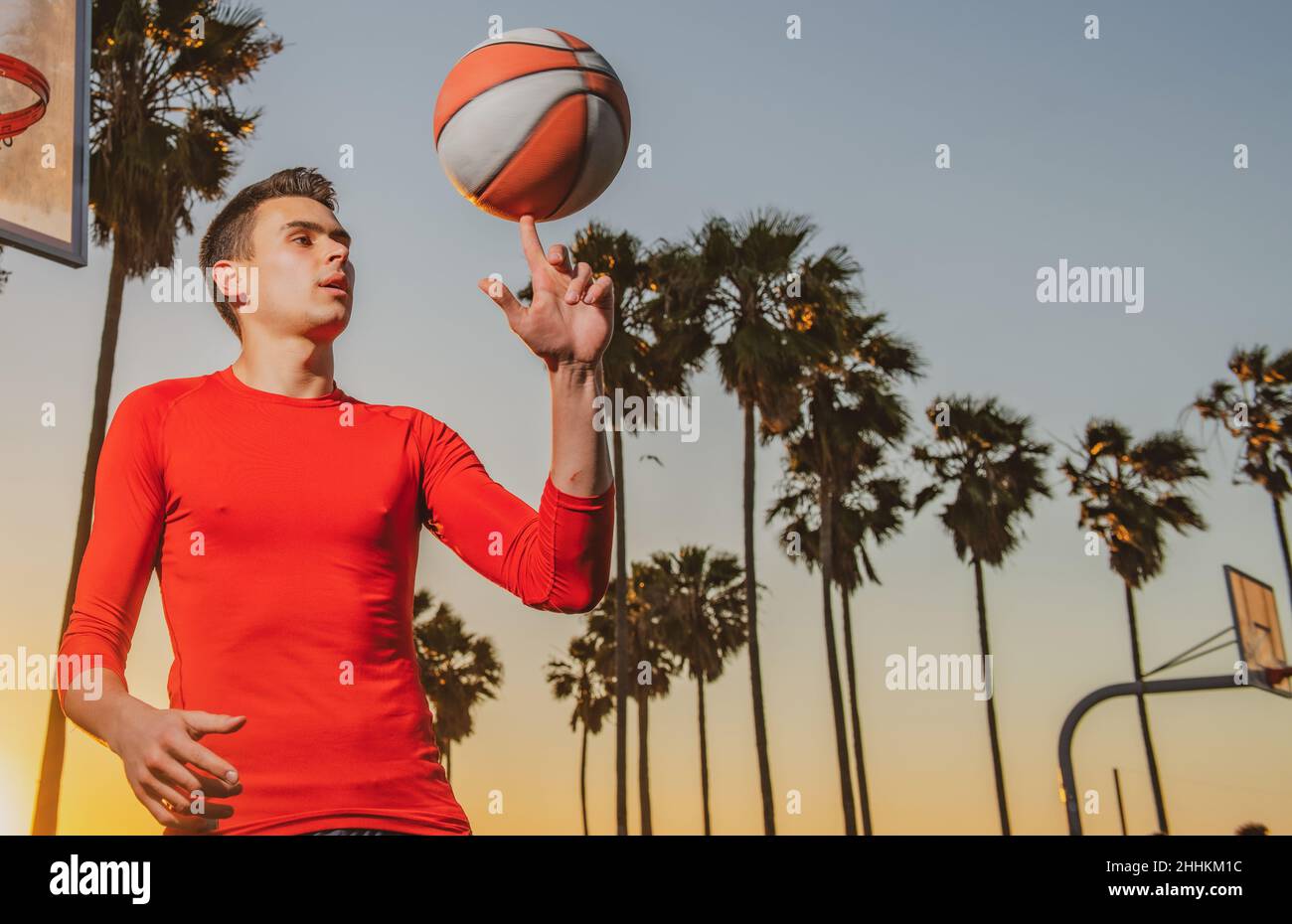 Basketball player. Hand spinning basket ball. Balancing basketball on