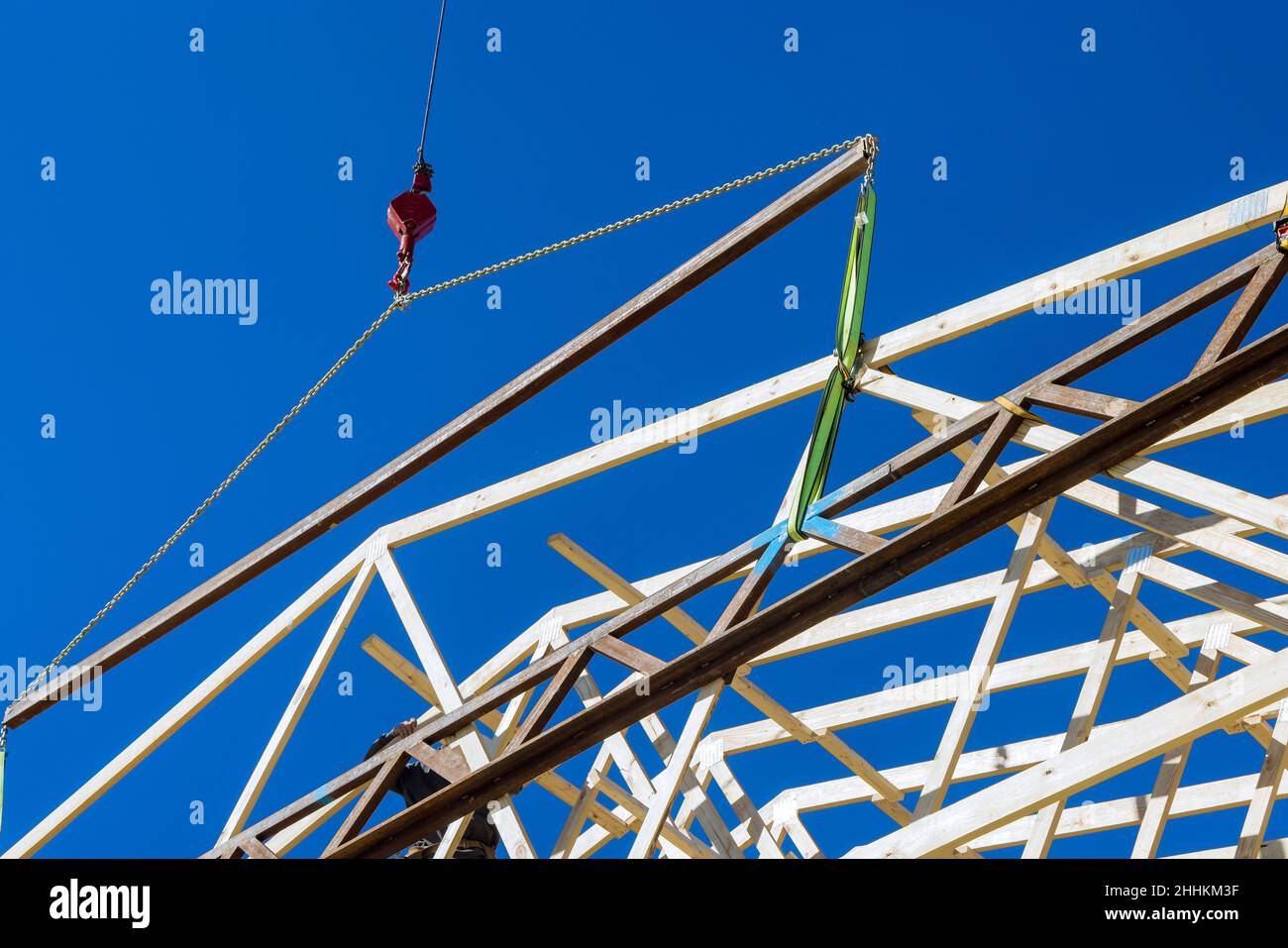 Building contractor carpenter placing new building wood engineered