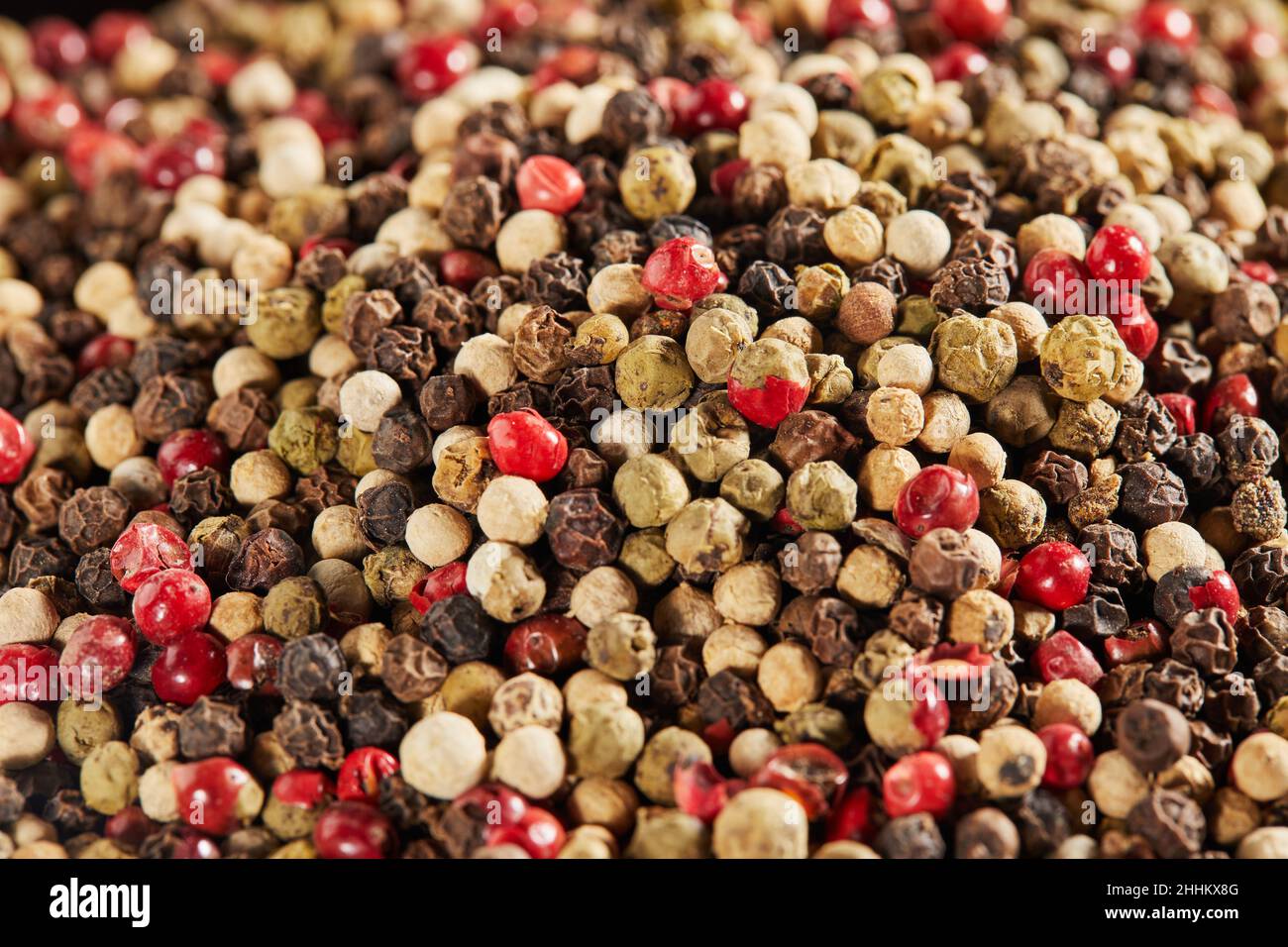 Texture background Multi-colored peppercorns on black plate. Stock Photo