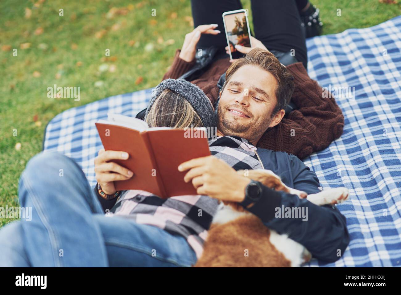 Young nice couple having fun on camping with dog Stock Photo - Alamy