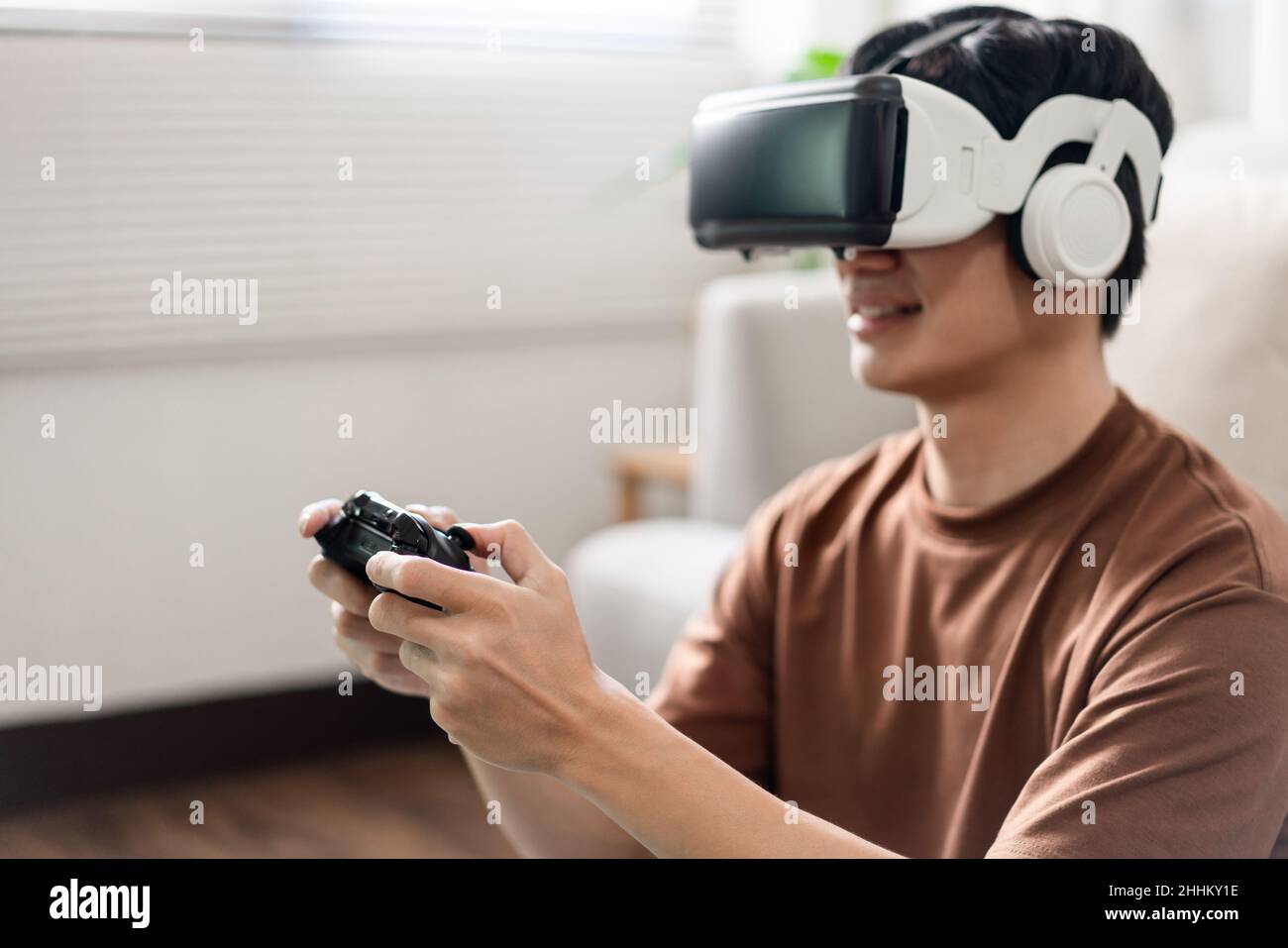 Technology Concept A man putting on a virtual reality headset and ...