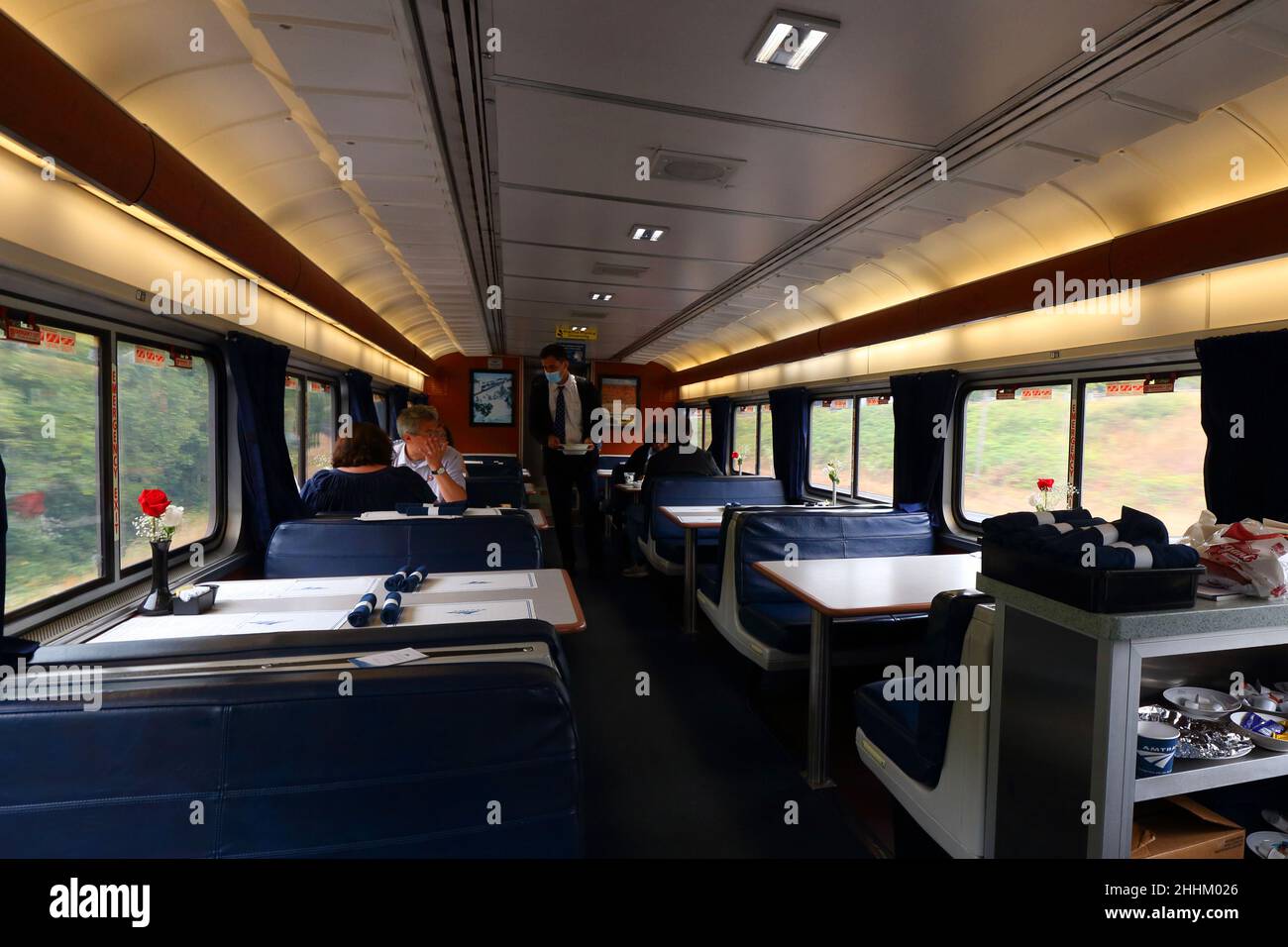People seated at tables onboard an Amtrak dining car on the Coast Starlight train. Stock Photo