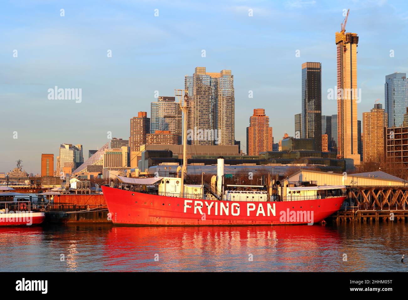 The Frying Pan lightship at Pier 66, Hudson River Park, New York. a historic ship at golden hour with the midtown manhattan skyline in the background. Stock Photo
