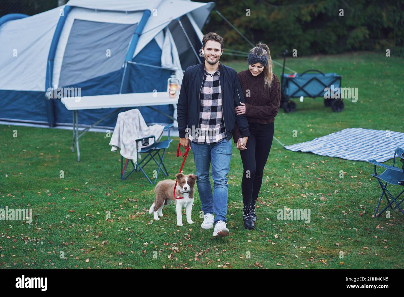Young nice couple having fun on camping with dog Stock Photo - Alamy