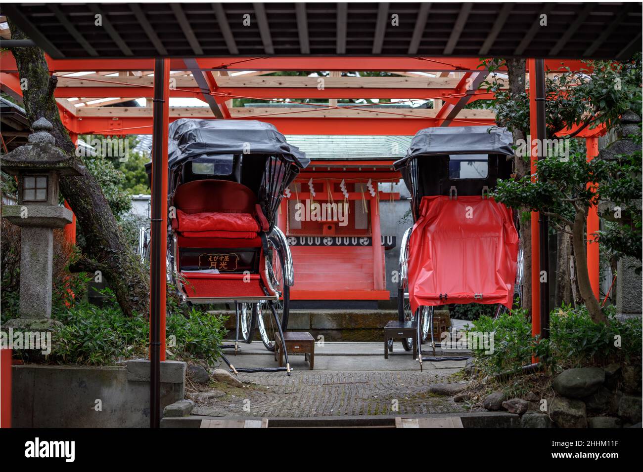 Rickshaws on display in a Japanese garden in Kyoto Stock Photo