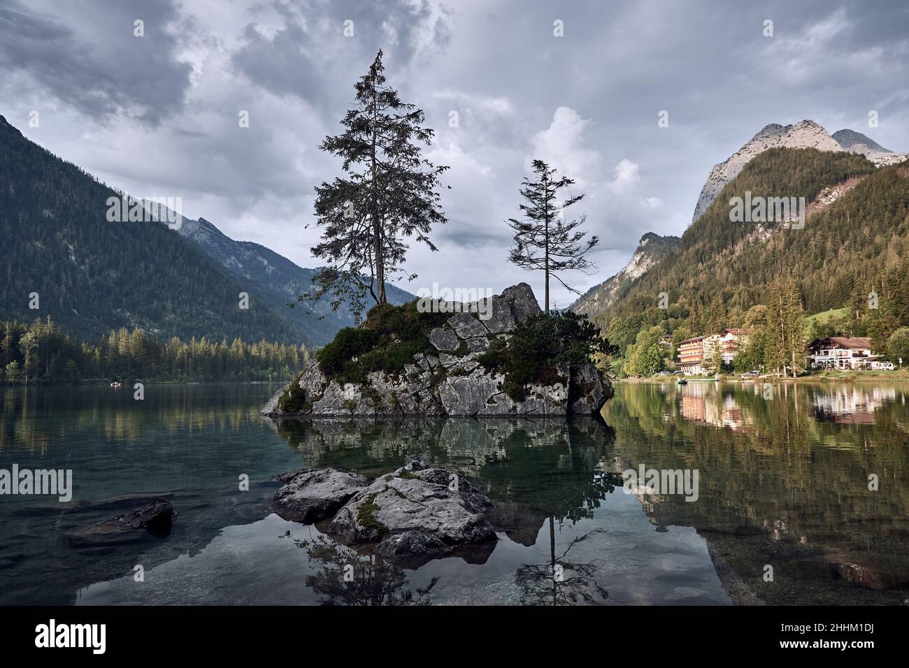 Idyllic landscape with trees growing on a rock in Lake Hintersee, Ramsau, Germany Stock Photo