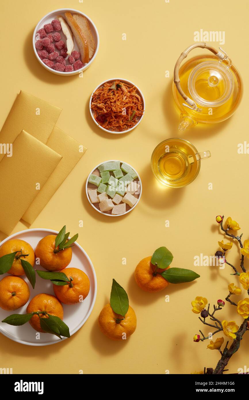 Chinese new year with mandarin orange teapot and candy , flower and red