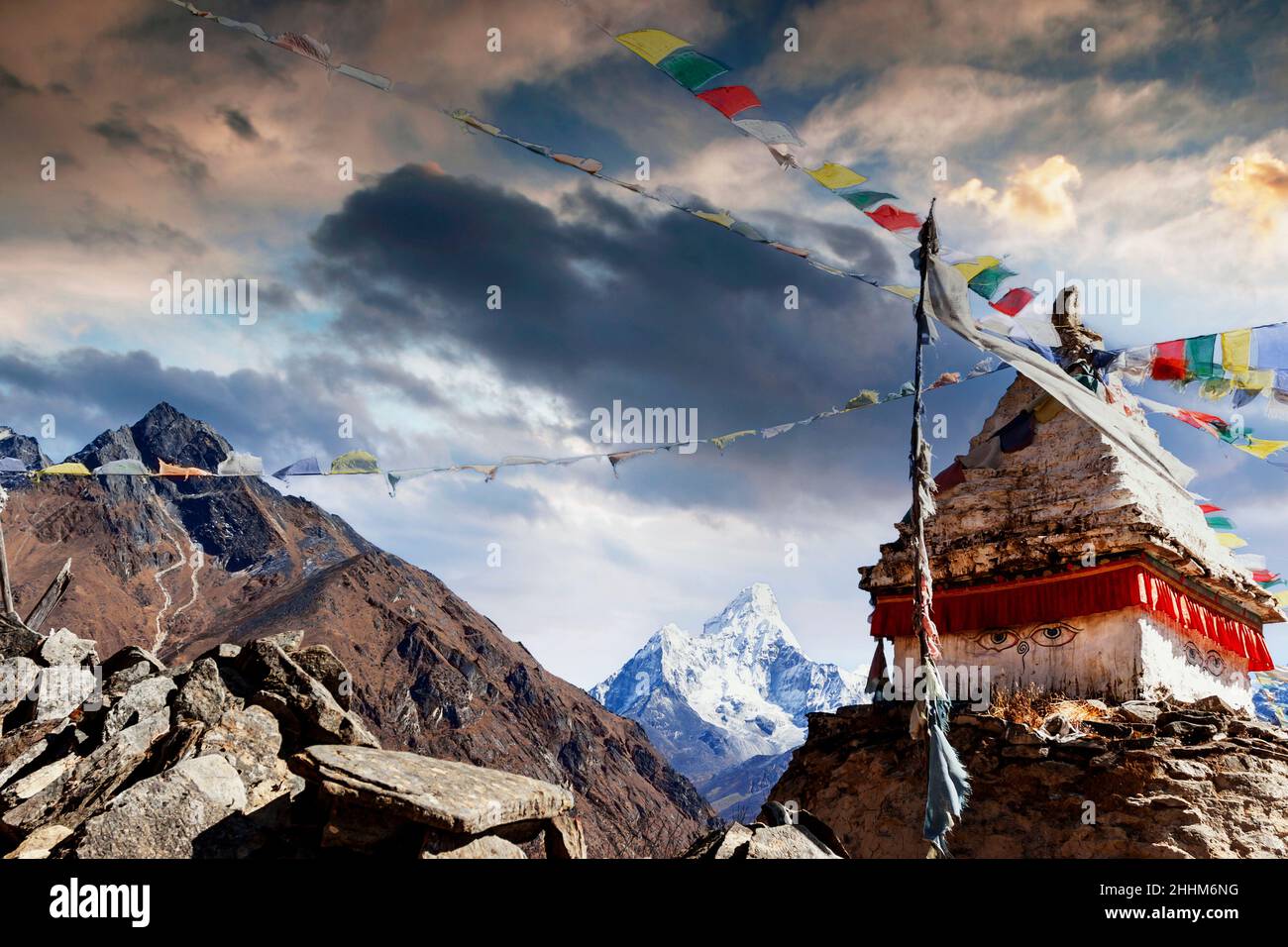 Prayer flags are blowing in the wind on the Ama Dablam in Nepal Stock Photo