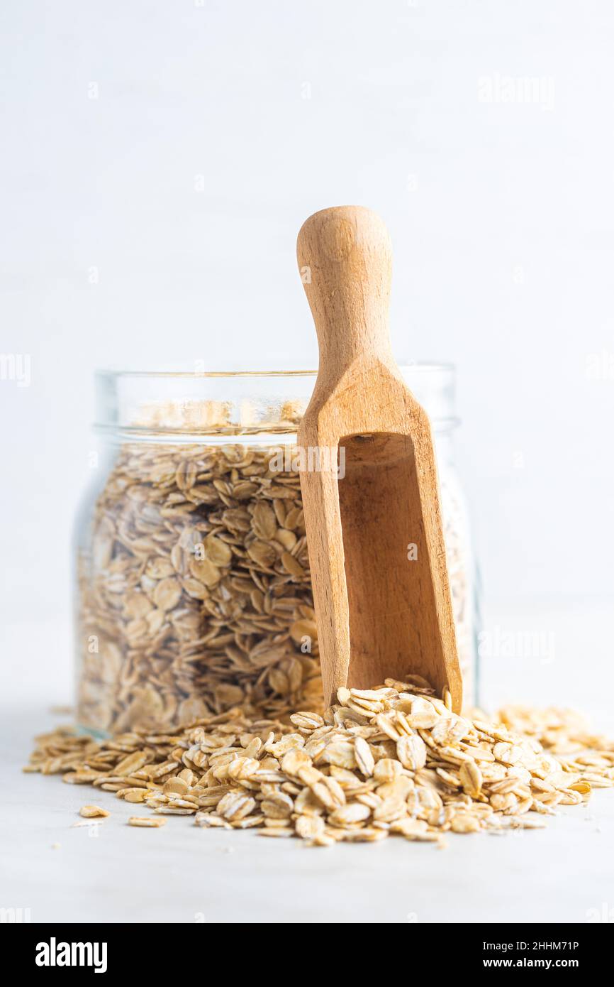 Breakfast cereals. Uncooked oatmeal. Raw oat flakes in jar. Stock Photo