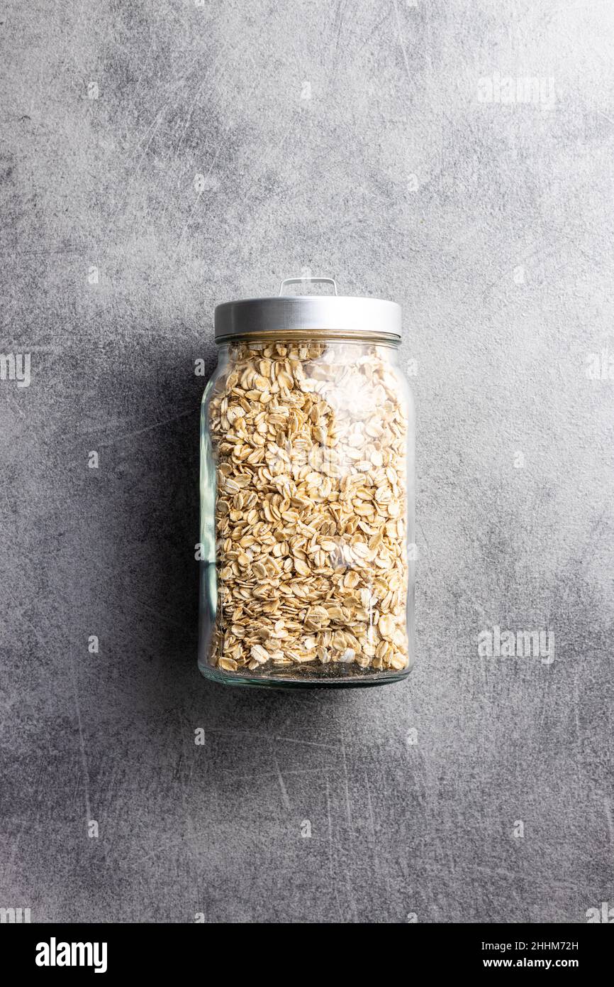 Breakfast cereals. Uncooked oatmeal. Raw oat flakes in jar. Top view. Stock Photo