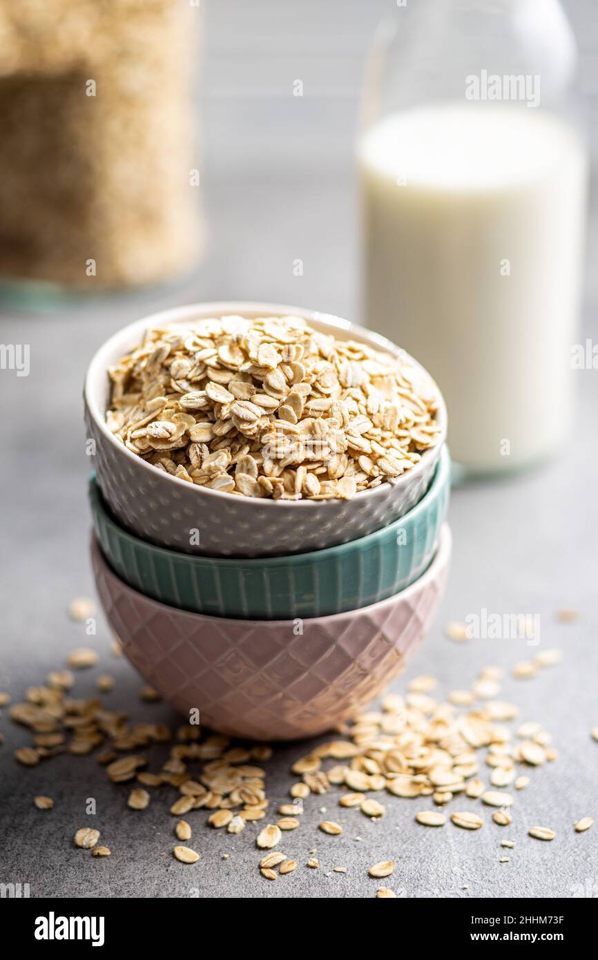 Breakfast cereals. Uncooked oatmeal. Raw oat flakes in bowl. Stock Photo