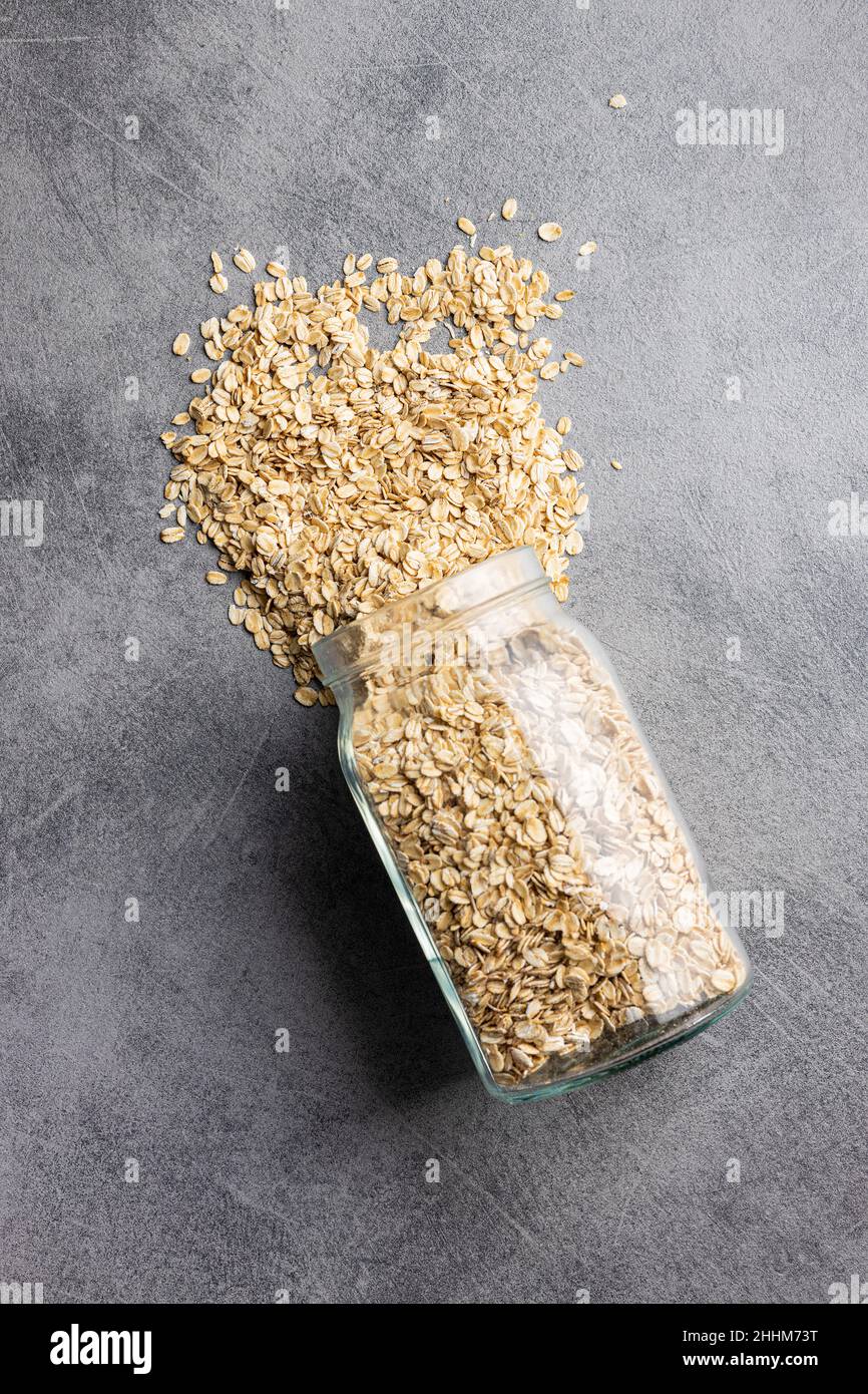 Breakfast cereals. Uncooked oatmeal. Raw oat flakes in jar. Top view. Stock Photo