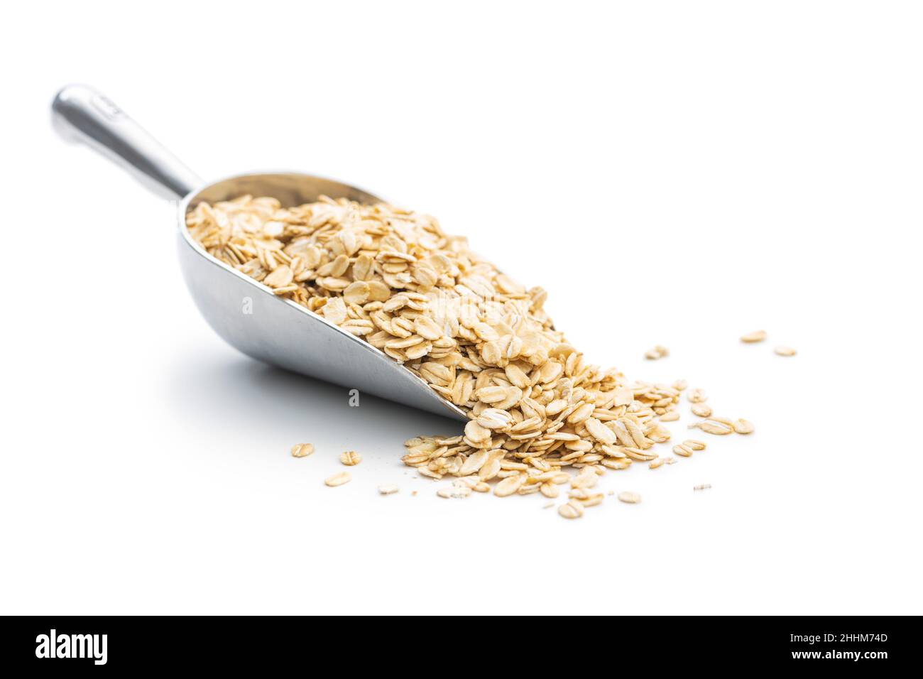 Breakfast cereals. Uncooked oatmeal. Raw oat flakes isolated on white background. Stock Photo