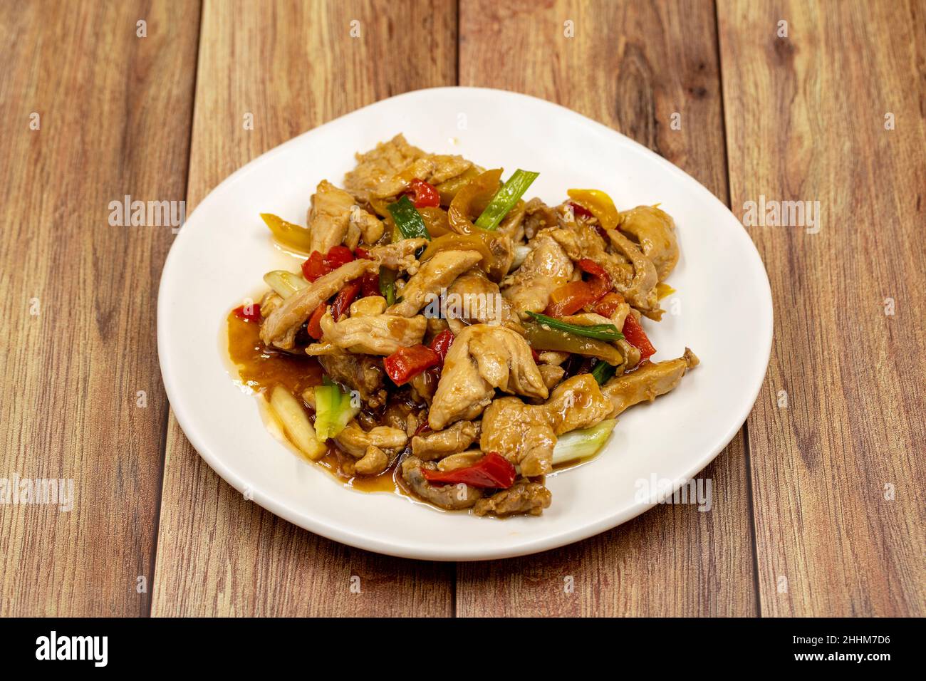 Chinese chicken dish. Chicken with olive oil and soy sauce. Traditional Chinese dish prepared with garlic, onion, capia pepper and green pepper Stock Photo