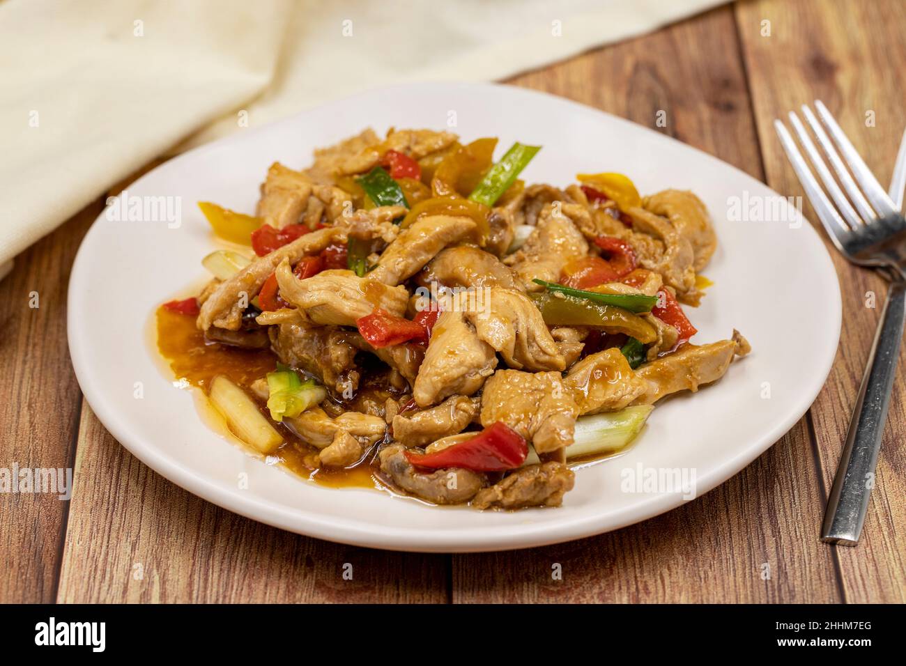 Chinese chicken dish. Chicken with olive oil and soy sauce. Traditional Chinese dish prepared with garlic, onion, capia pepper and green pepper Stock Photo