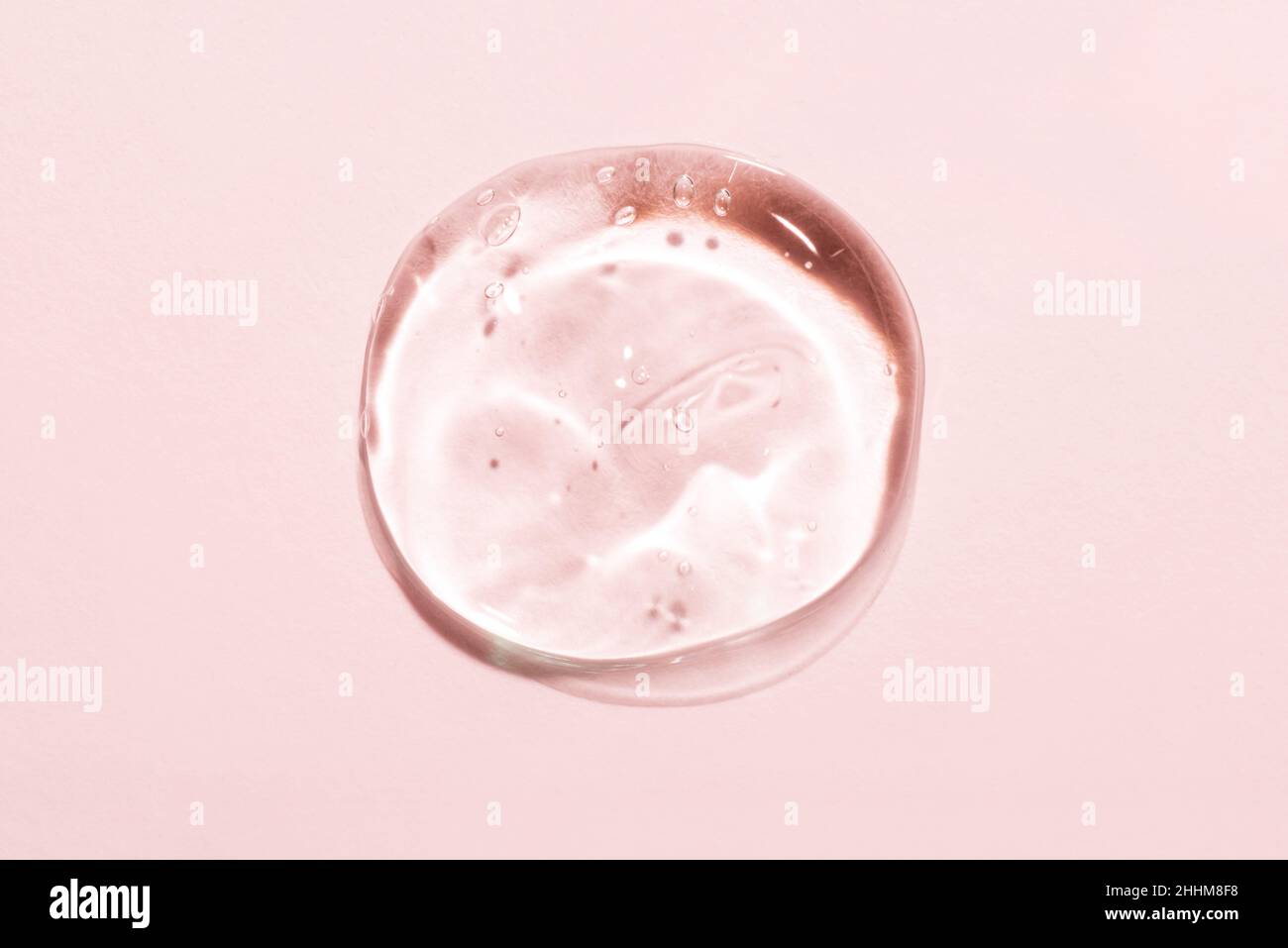 Transparent hyaluronic acid gel on a pink background. Stock Photo