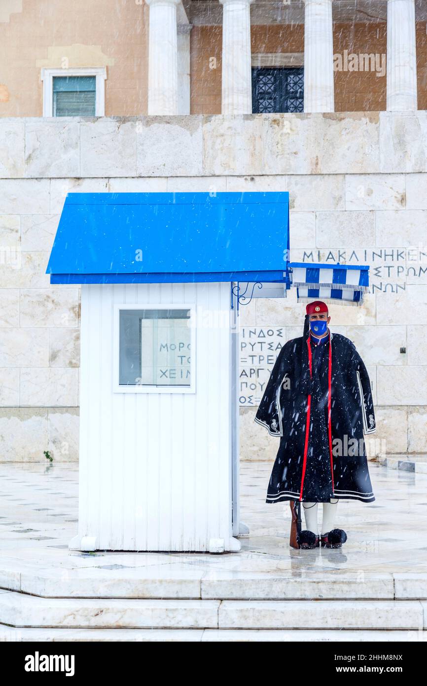 Soldier of the Greek Presidential Guard (Evzonas) standing firm despite the snowfall, in Greek Parliament, Athens, Greece, Stock Photo