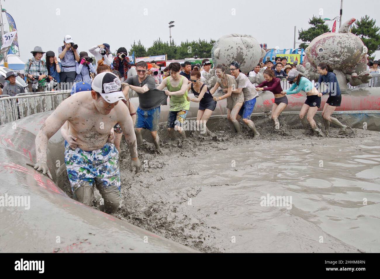 July 18, 2015 - South Korea, Boryeong : Visotors play in a mud pool during the Boryeong Mud Festival at Daecheon Beach in Boryeong , South Korea, The 18th annual mud festival features mud wrestling and mud sliding. Stock Photo