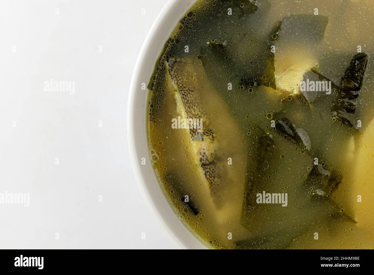 Broth dish with flounder. Dishes with seafood and seaweed. Korean food