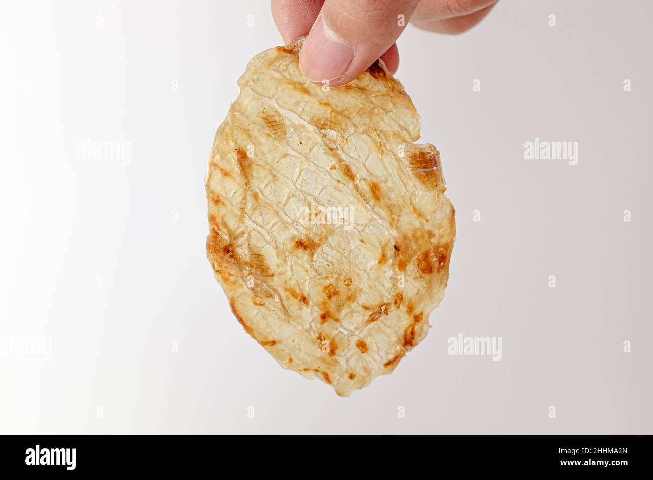 Dried filefish fillet on white background Stock Photo - Alamy