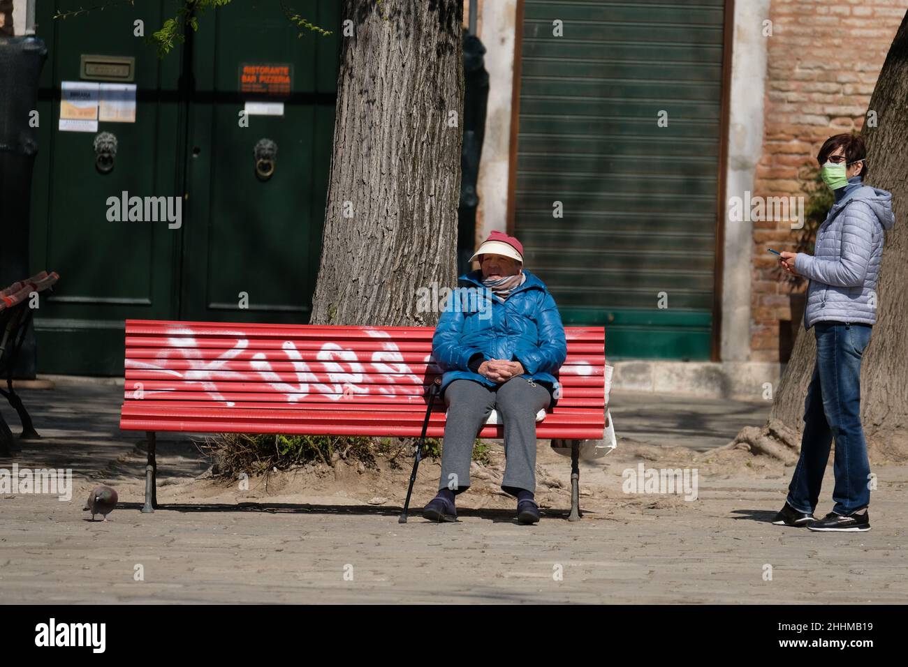 A disabled man sits on a bench during lockdown for coronavirus disease. Stock Photo