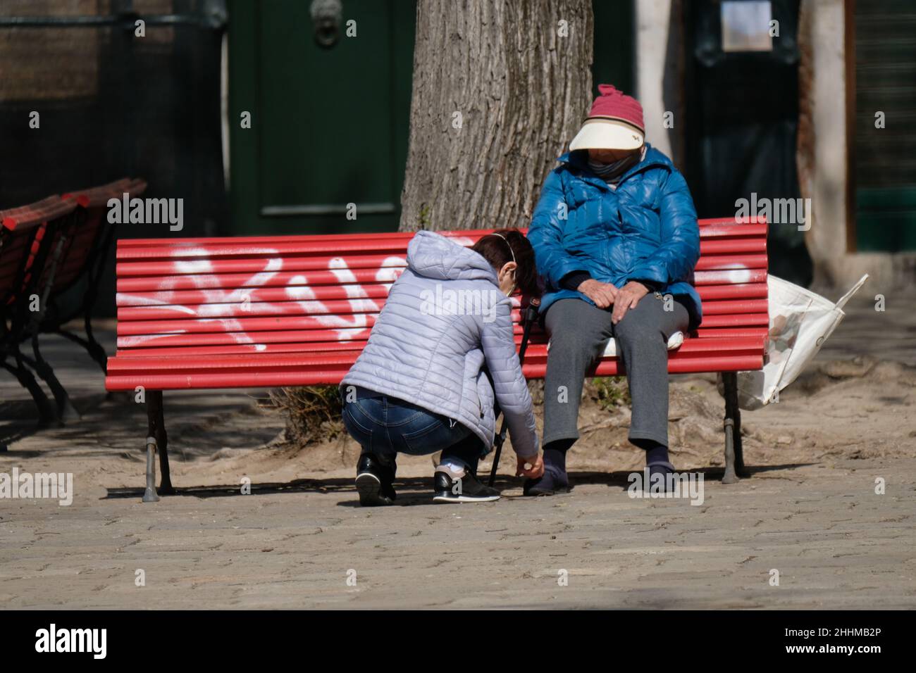 A disabled man sits on a bench during lockdown for coronavirus disease. Stock Photo