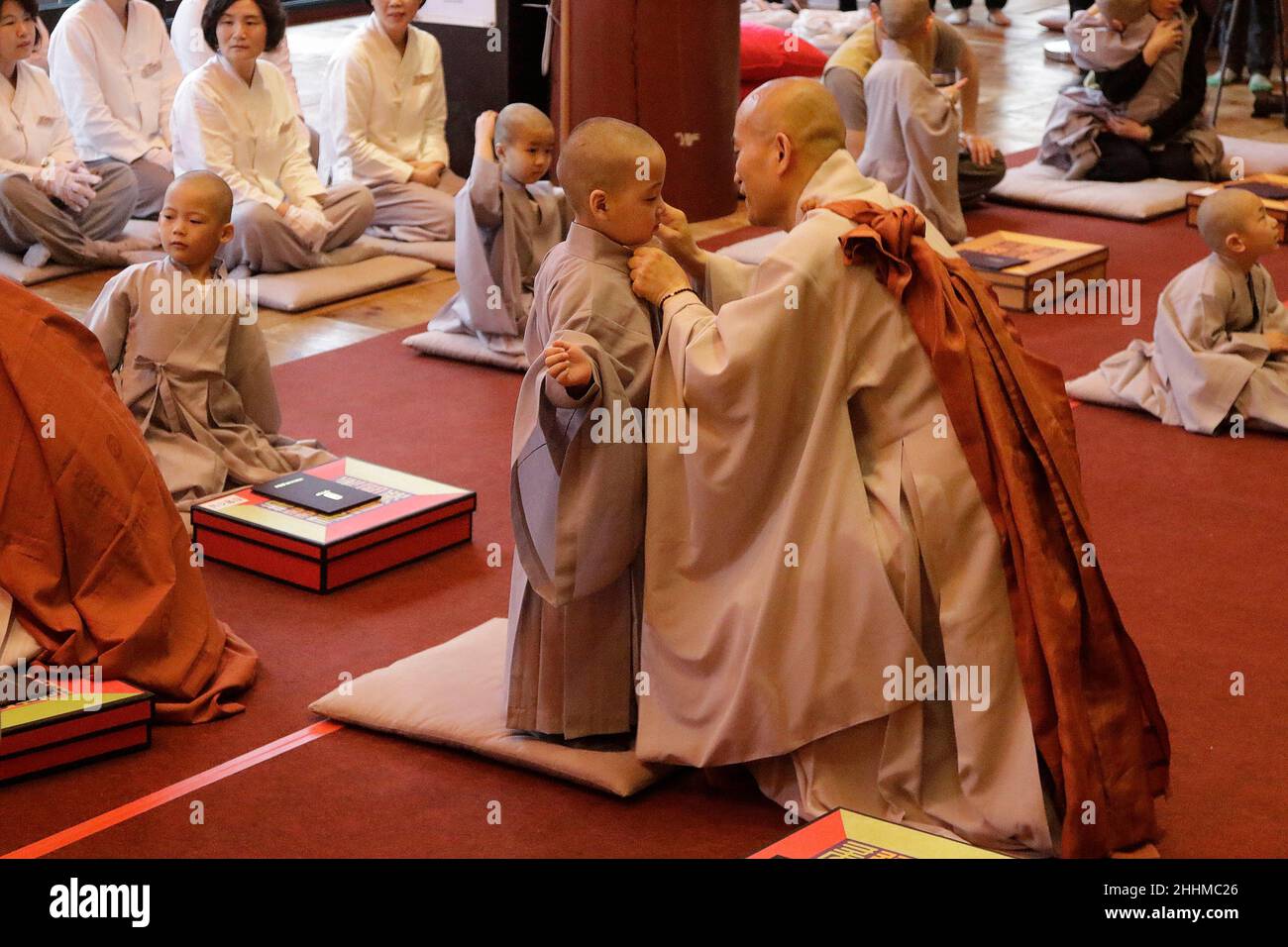May 2, 2018-Seoul, South Korea-A child gets his head shaved by a Buddhist monk during the 'Children Becoming Buddhist Monks' ceremony forthcoming buddha's birthday at a Chogye temple in Seoul, South Korea. Children have their hair shaved off during the 'Children Becoming Buddhist Monks' ceremony ahead of buddha's birthday at a Chogye temple. The children will stay at the temple to learn about Buddhism for 20 days. Buddha was born approximately 2,562 years ago, and although the exact date is unknown, Buddha's official birthday is celebrated on the full moon in May in South Korea, which is on Ma Stock Photo