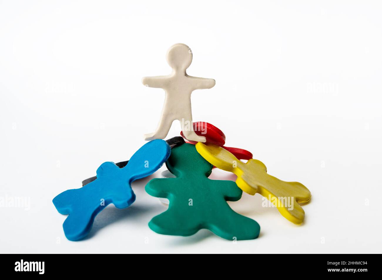 A plasticine man standing on top of other plasticine men. Leadership concept. Conceptual image of teamwork on white Stock Photo