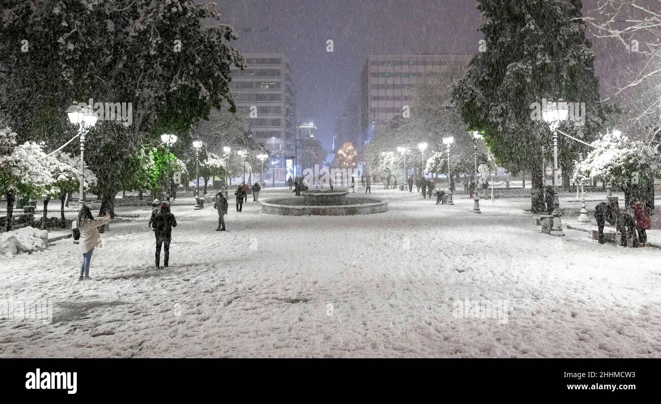Snowstorm in Athens, Greece, in Syntagma Square, the most central square in Athens. People are having fun playing in the snow enjoying the opportunity Stock Photo
