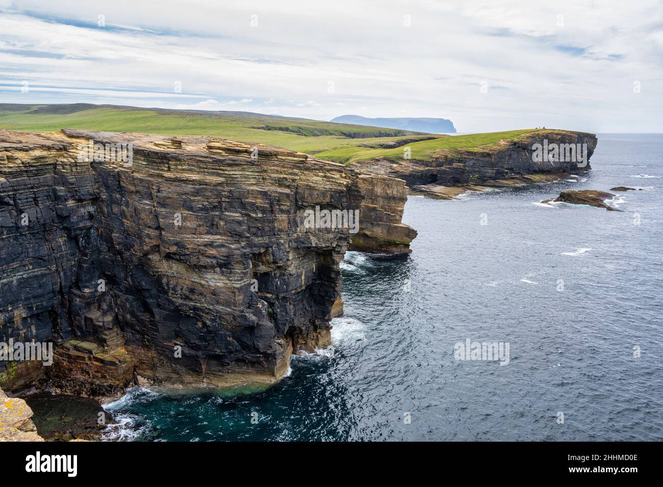 Yesnaby coastline looking south towards Brough of Bigging headland with distant view of Hoy - west coast of Mainland Orkney in Scotland Stock Photo