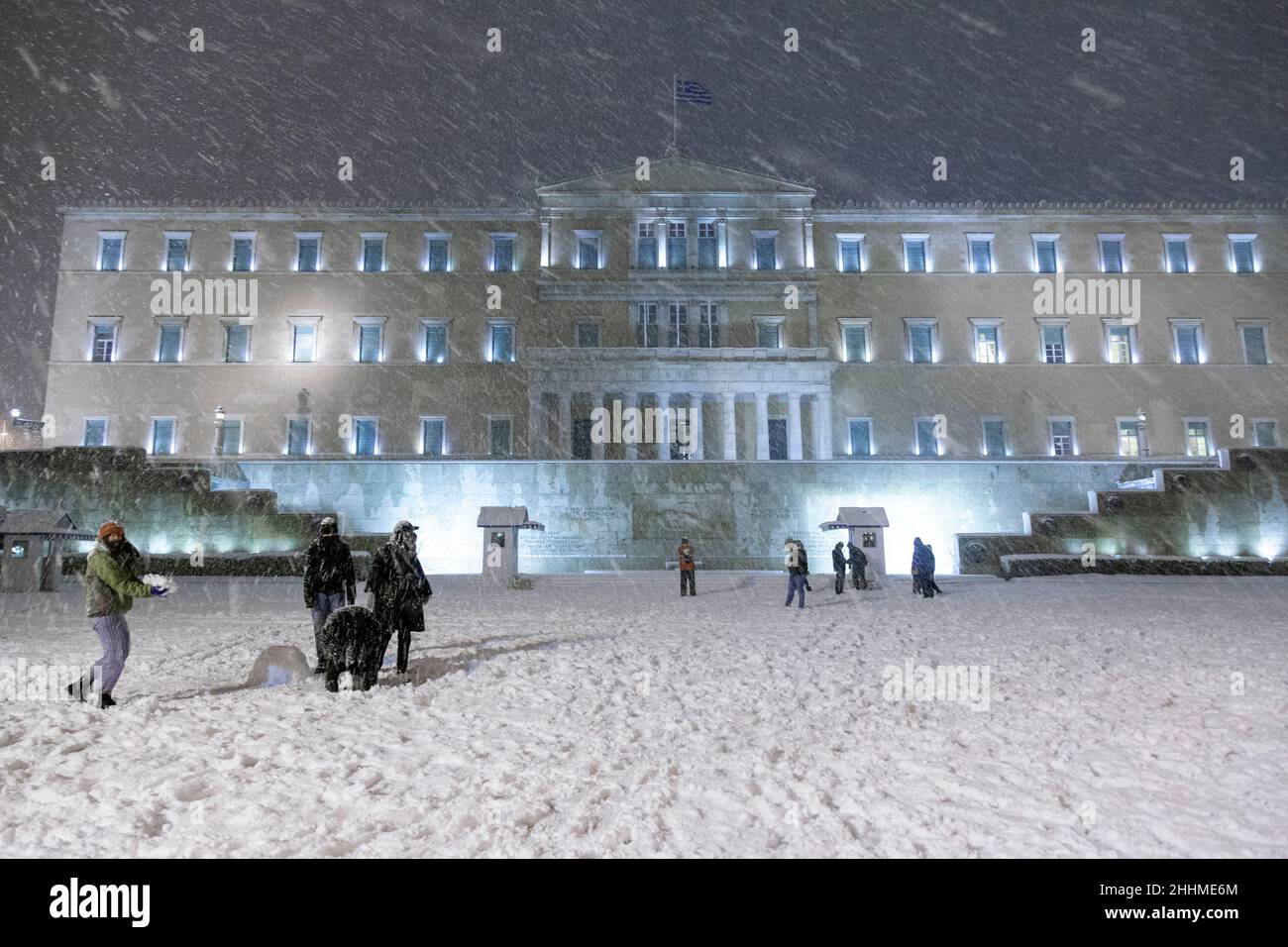 Snowfall in Athens, Greece, and people are having fun playing with the snow in front of the Parliament, in Syntagma Square. Stock Photo