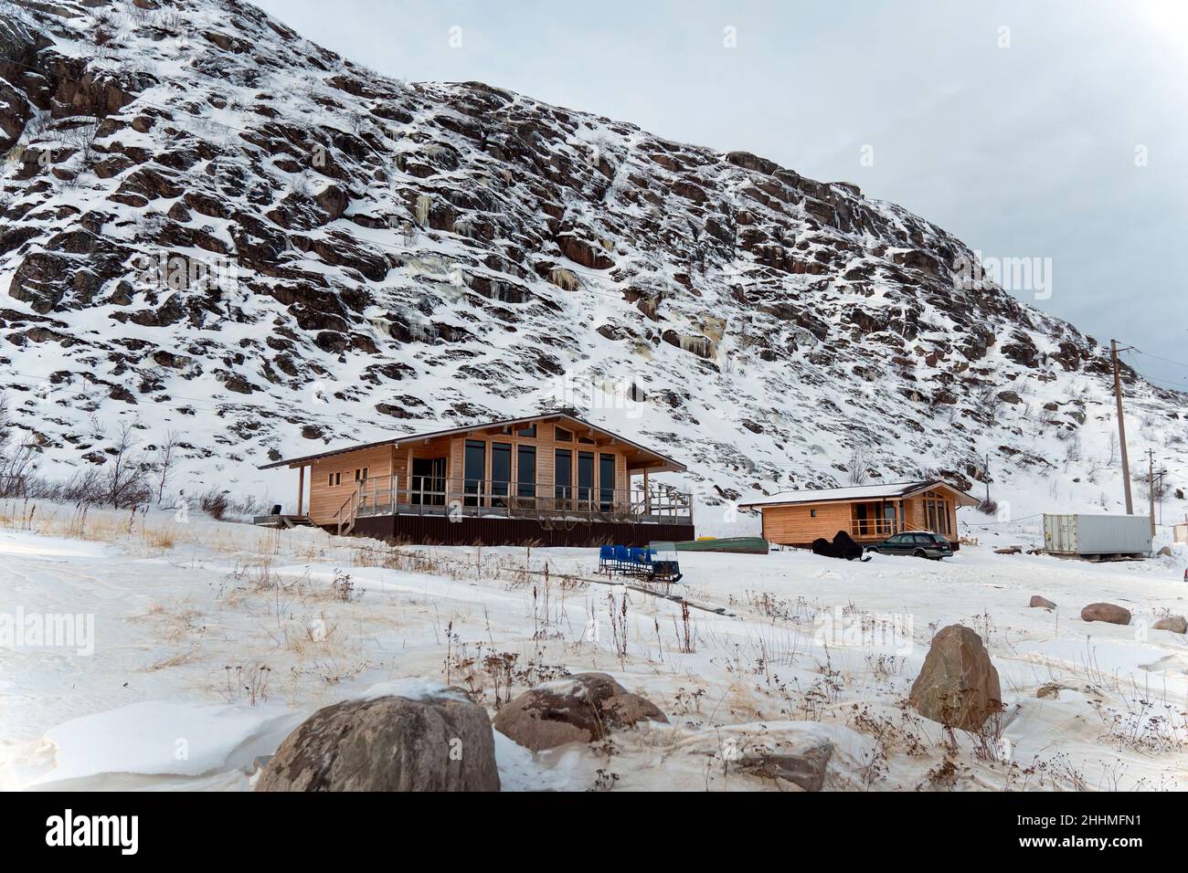 resort wooden houses at the foot of the mountain in the snow in winter ...