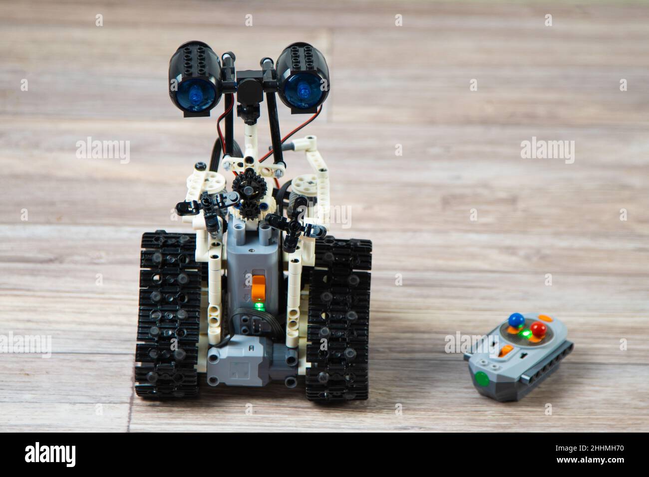 The robot from the children's designer on the control panel. DIY educational toy. A radio-controlled robot rides on the floor. Robotics in action. Robot from the constructor. Stock Photo