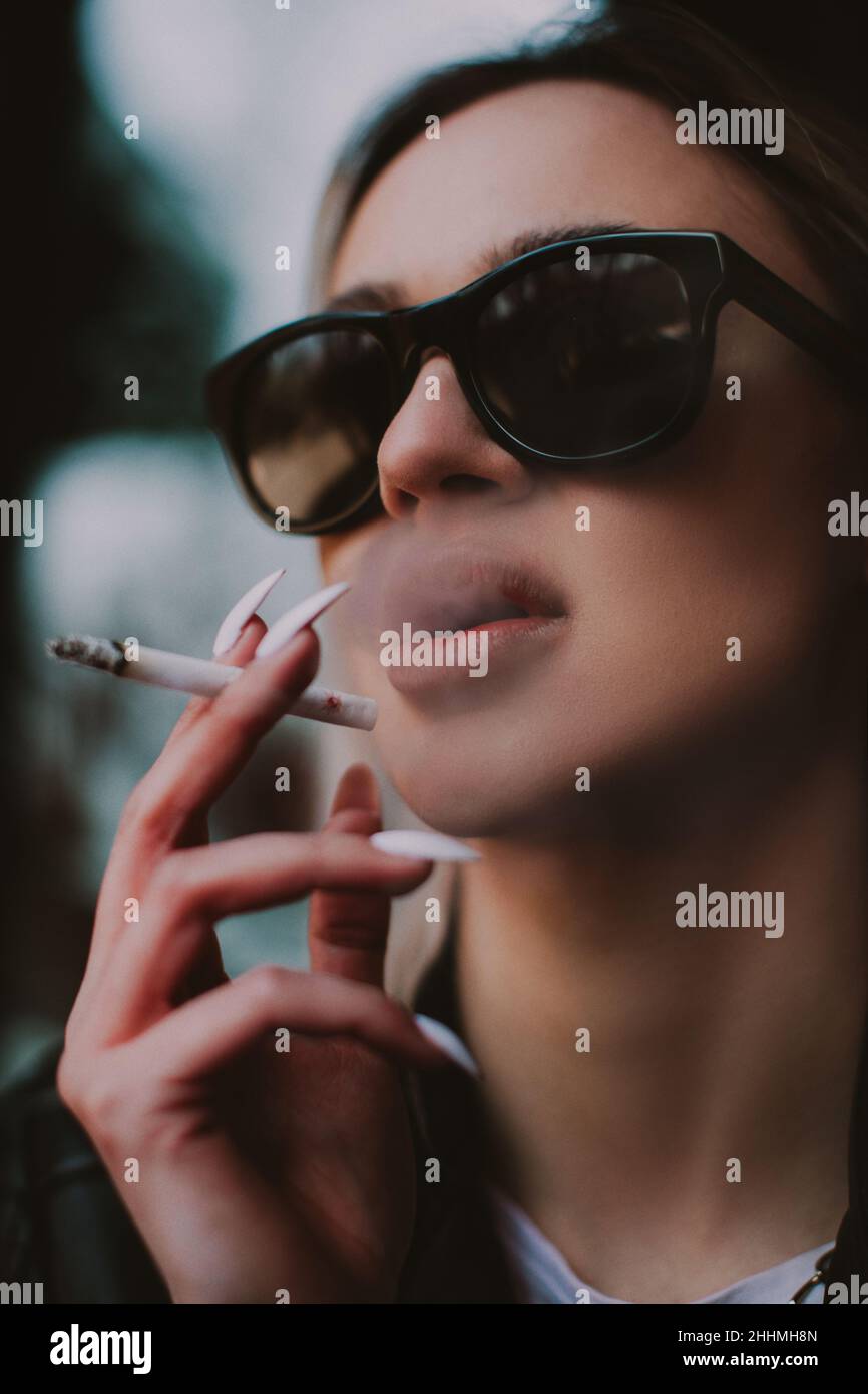 Young woman smoking cigarette lips hi-res stock photography and images