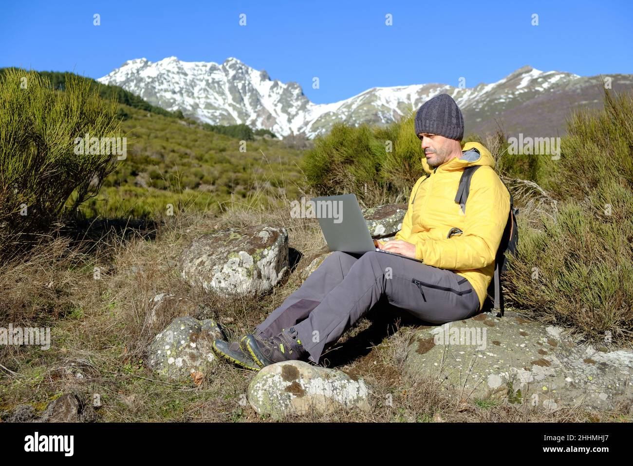 Man working with a laptop computer in nature. Health at work Stock Photo