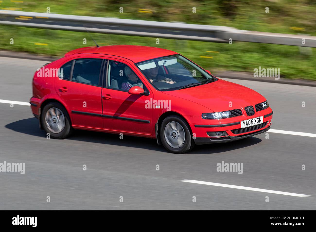 2005 red SEAT Leon SX 1598cc 5 speed manual; vehicular traffic, moving vehicles, petrol classic sports car, english, england, uk roads, motors, motoring, moving, cars driving vehicle, being driven, transport, travel, cars driving vehicle, in motion, uk Stock Photo