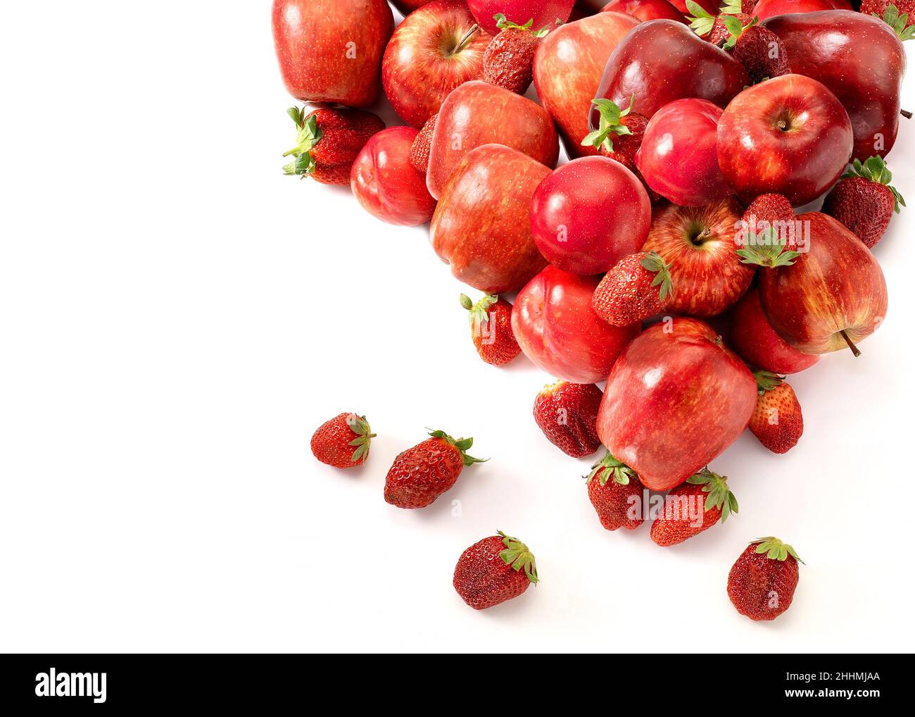 Plums, apples and strawberry fruits arrangement up view with a copy space. Red color setting. Stock Photo