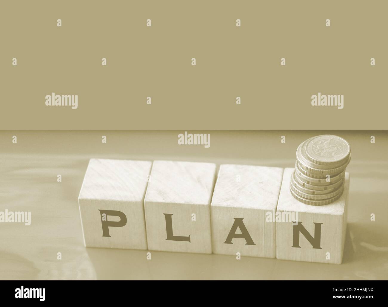 word plan made with letters on wooden blocks and stack of coins. Business plan Stock Photo