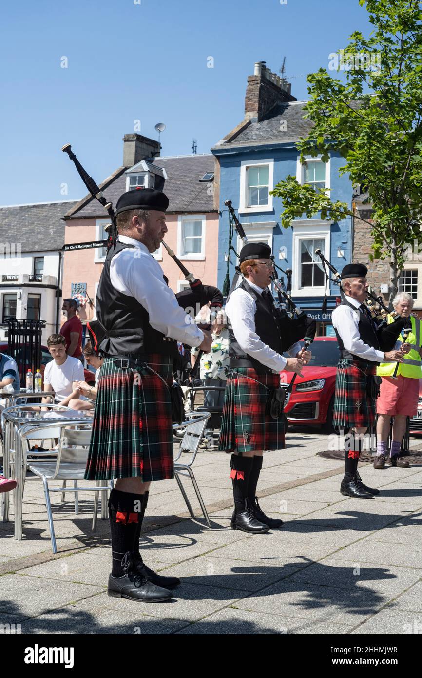 Pipers play in the centre of Duns, Berwickshire, Scotland during the town's annual civic week festival Stock Photo
