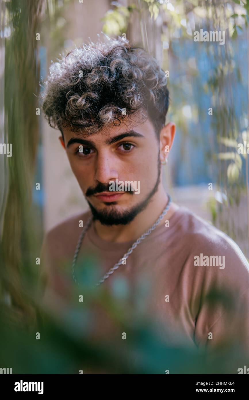 Portrait of an attractive young Spanish man with hair highlights and