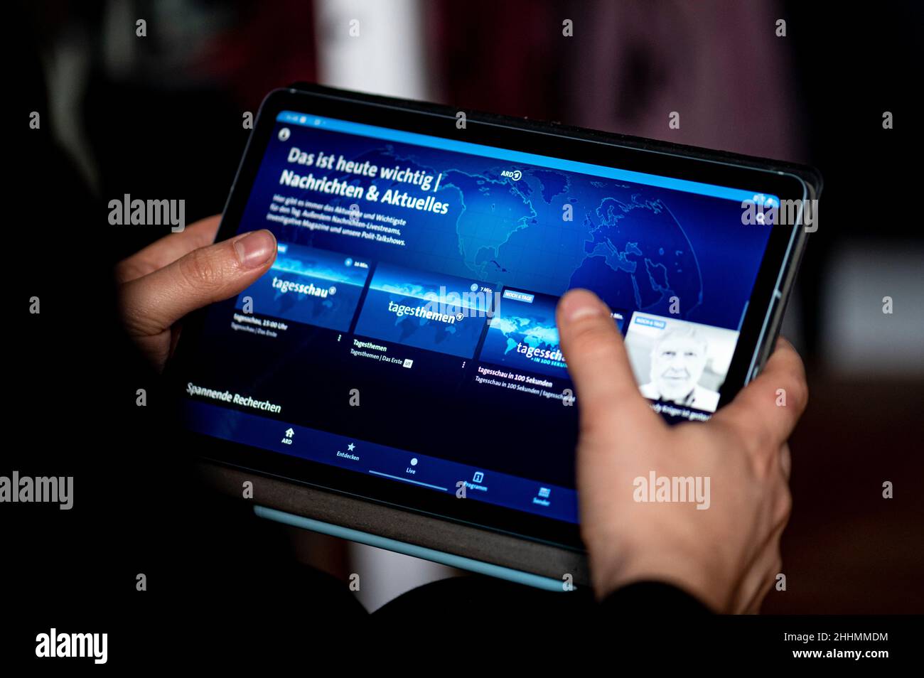 Berlin, Germany. 20th Jan, 2022. A man uses the ARD-Mediathek app on a tablet to watch the Tagesschau. Credit: Fabian Sommer/dpa/Alamy Live News Stock Photo