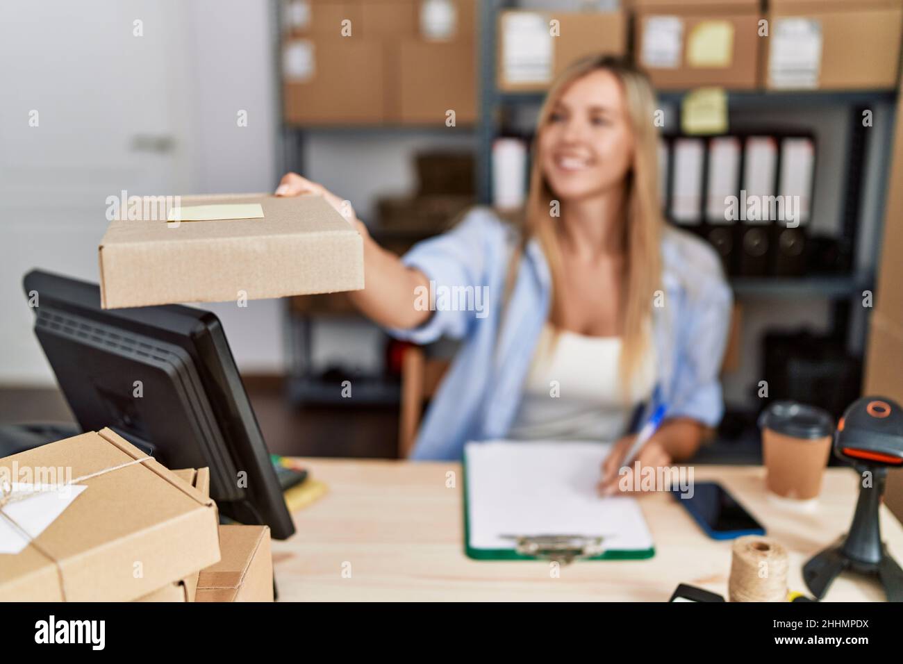 Young blonde woman ecommerce business worker holding order package ...