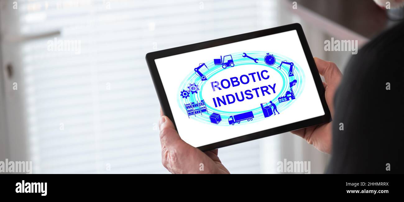 Robotic industry concept shown on a tablet held by a man Stock Photo