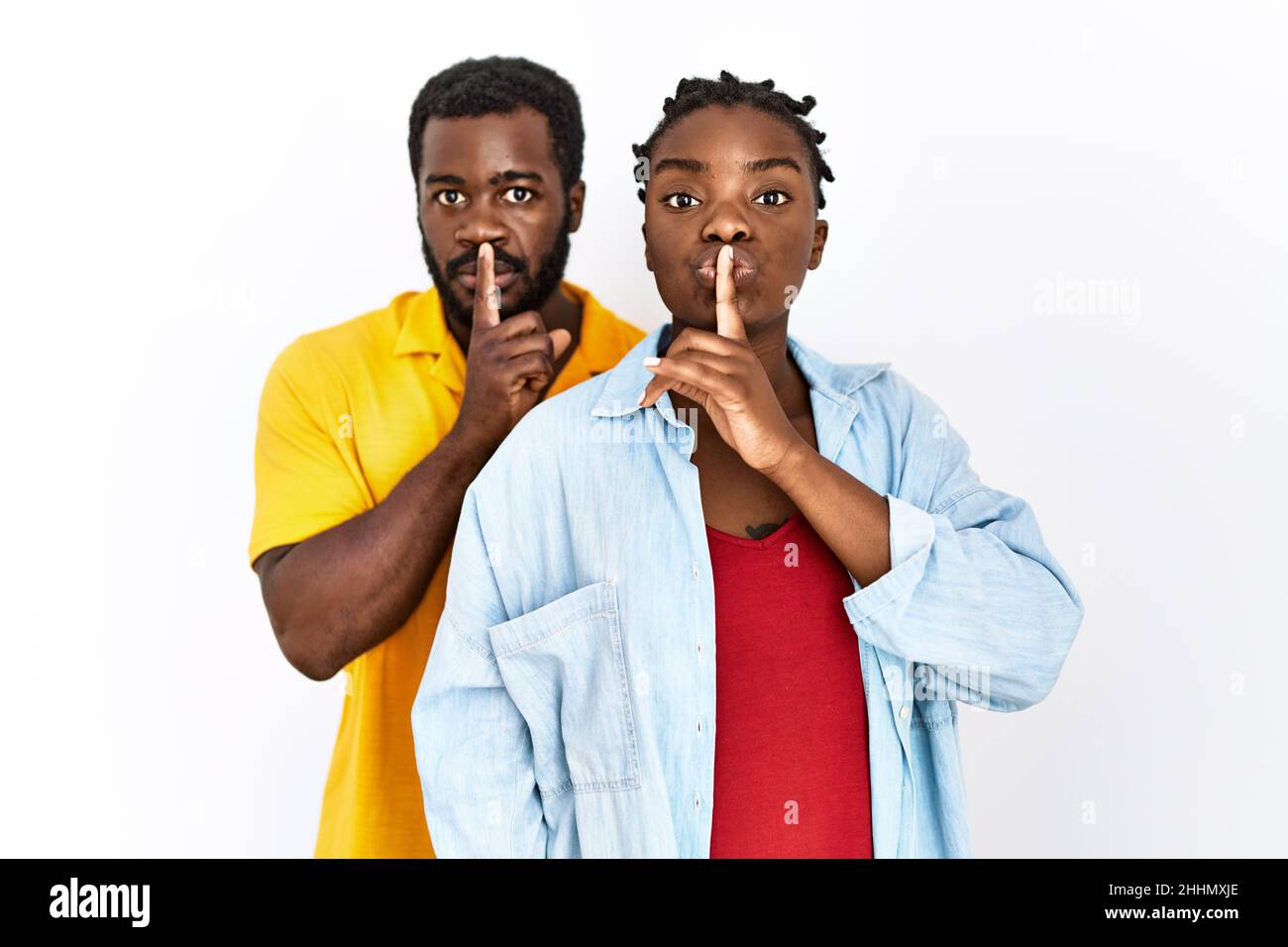 Young african american couple wearing casual clothes asking to be quiet ...